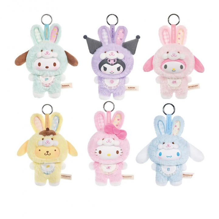 Set of six colorful plush keychains with bunny designs on a white background